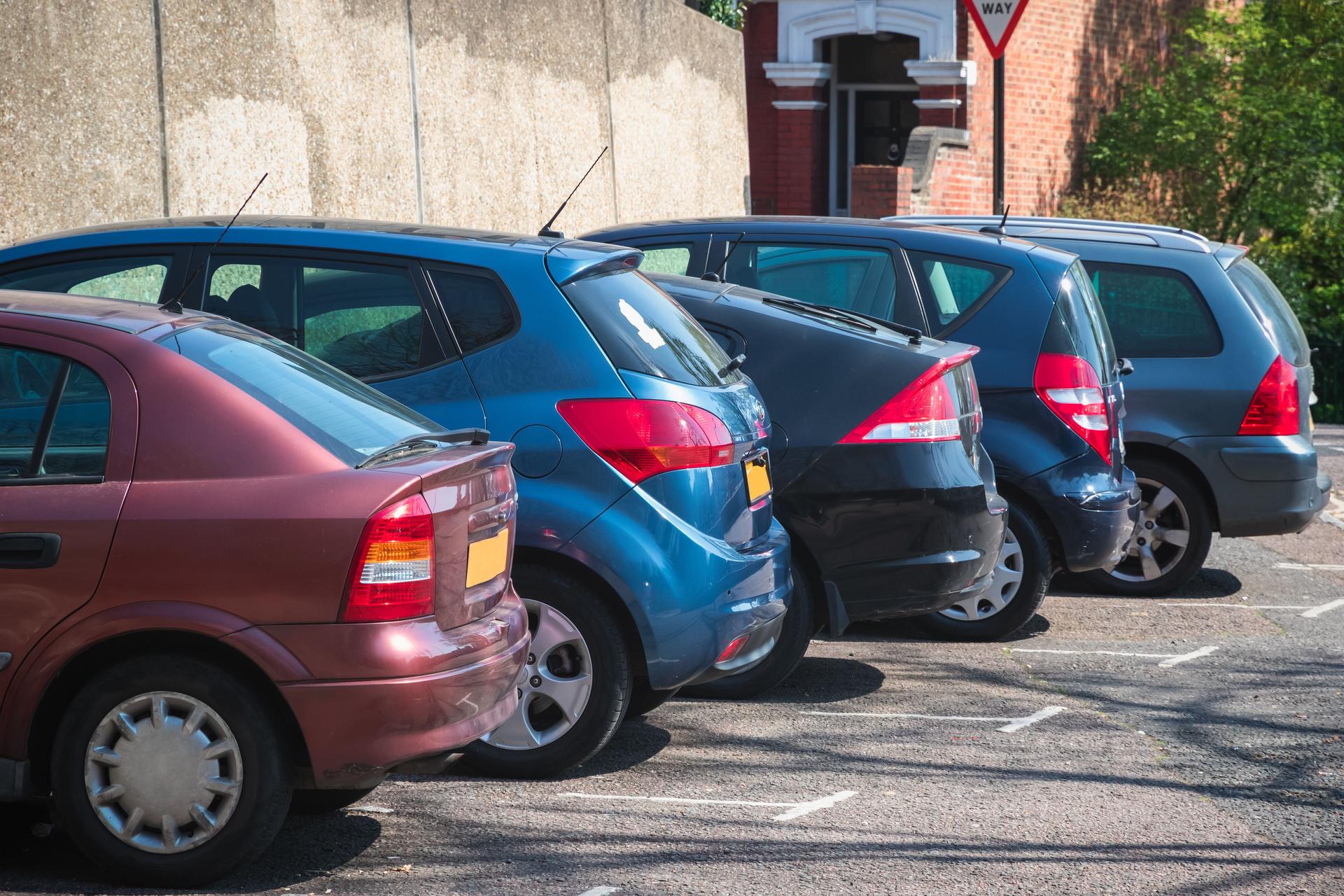 Cars parked in row on outdoor parking in London